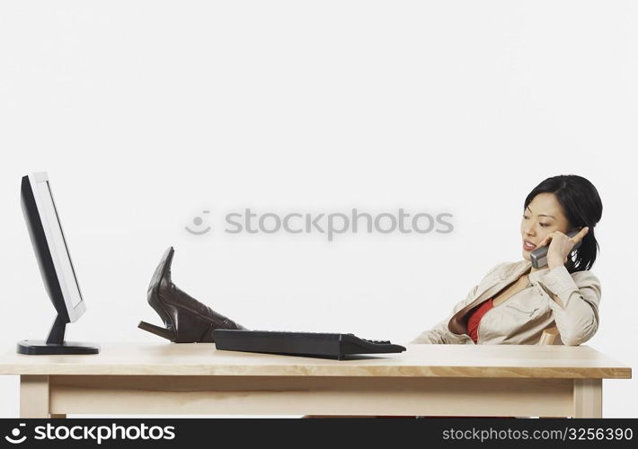 Side profile of a businesswoman talking on a cordless telephone