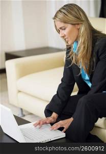 Side profile of a businesswoman using a laptop
