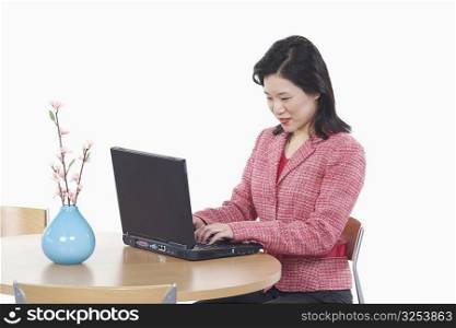 Side profile of a businesswoman using a laptop