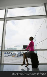 Side profile of a businesswoman using a laptop in a waiting room