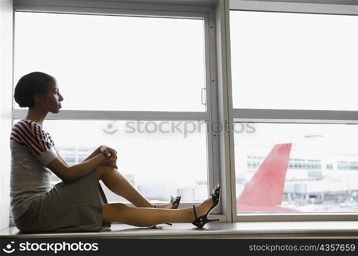 Side profile of a businesswoman waiting in a waiting room at an airport