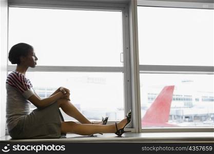 Side profile of a businesswoman waiting in a waiting room at an airport