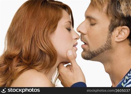 Side profile of a couple kissing each other