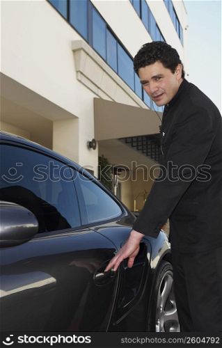 Side profile of a doorman opening a car door
