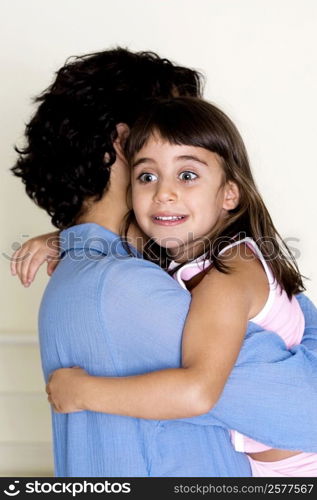 Side profile of a father carrying his daughter