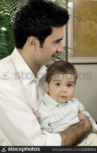 Side profile of a father holding his son