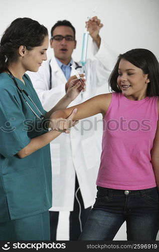 Side profile of a female doctor giving an injection to a girl