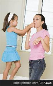 Side profile of a girl feeding her mother