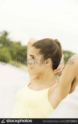 Side profile of a girl holding her hair
