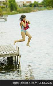 Side profile of a girl jumping into a lake
