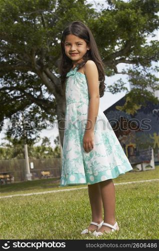 Side profile of a girl standing in a park