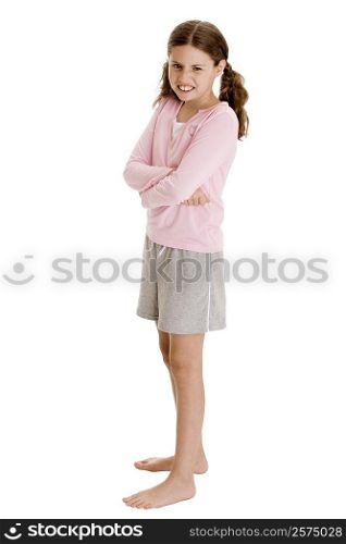 Side profile of a girl standing with her arms crossed
