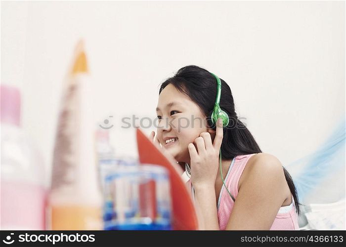 Side profile of a girl wearing headphones listening to music