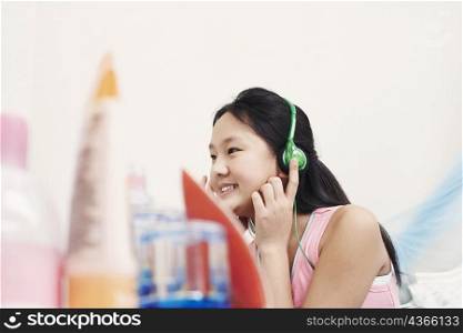 Side profile of a girl wearing headphones listening to music