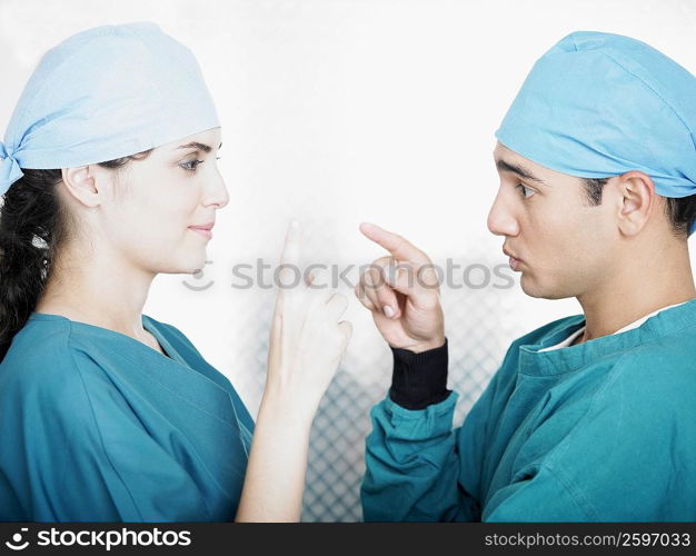 Side profile of a male and a female doctor