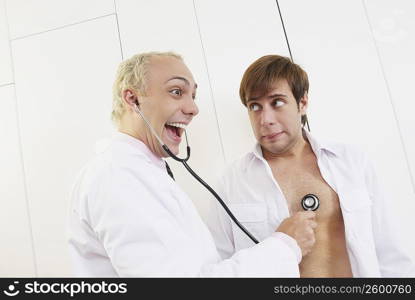 Side profile of a male doctor examining a patient with a stethoscope