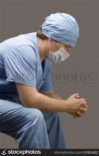 Side profile of a male surgeon thinking