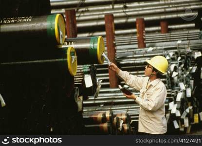 Side profile of a male worker inspecting at a steel mill, Kawasaki, Honshu, Japan