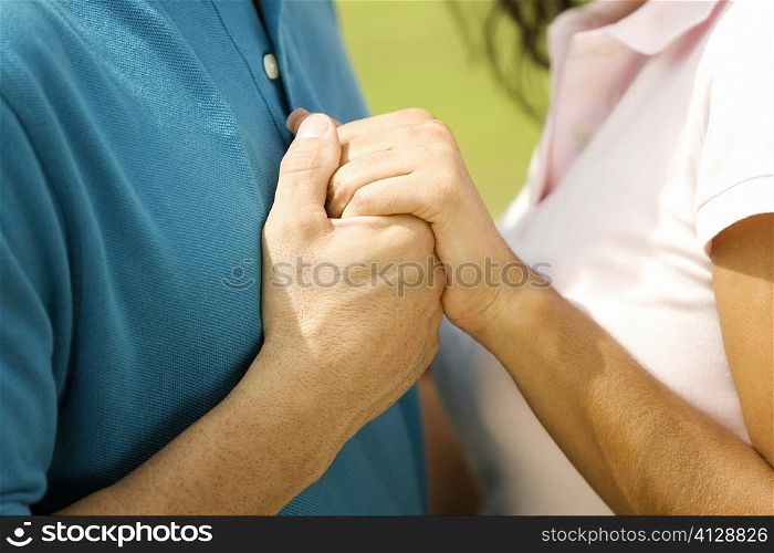 Side profile of a man and a woman holding hands