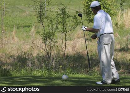 Side profile of a man holding a golf club