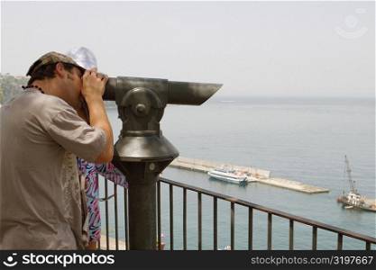 Side profile of a man looking through a coin-operated binocular, Bay of Naples, Via Aniello Califano, Sorrento, Sorrentine Peninsula, Naples Province, Campania, Italy