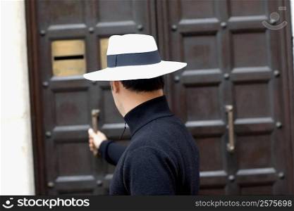 Side profile of a man opening the door