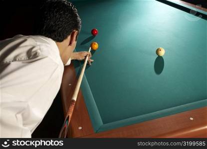 Side profile of a man playing pool