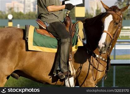 Side profile of a man riding a horse