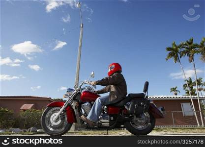 Side profile of a man riding a motorcycle