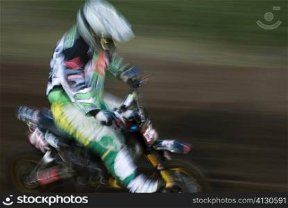 Side profile of a man riding a motorcycle in a sports race