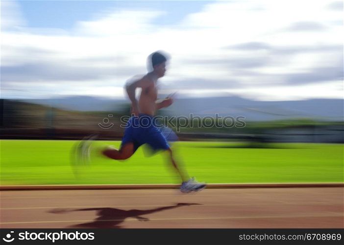 Side profile of a man running on a track