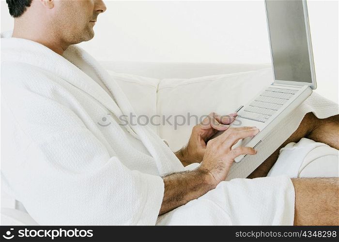Side profile of a man using a laptop