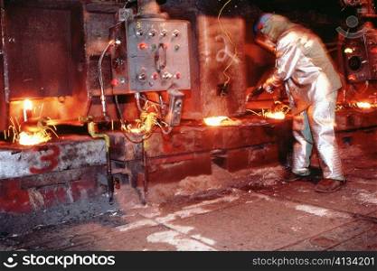 Side profile of a manual worker working in a steel plant