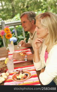 Side profile of a mature couple sitting at the table