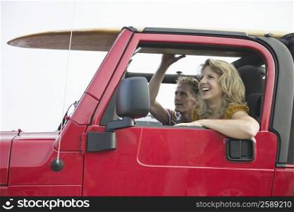 Side profile of a mature couple smiling in a jeep