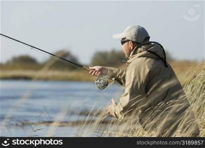 Side profile of a mature man fishing