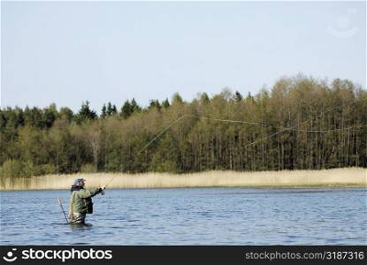 Side profile of a mature man fishing in the river