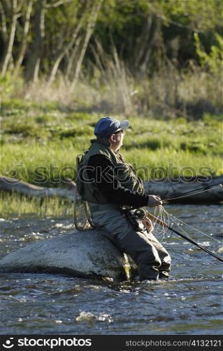 Side profile of a mature man fishing in the river