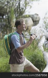 Side profile of a mature man holding binoculars