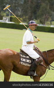 Side profile of a mature man playing polo