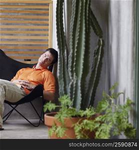 Side profile of a mature man sitting on a chair and sleeping