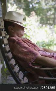 Side profile of a mature man sleeping on a chair