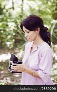 Side profile of a mature woman holding a camera