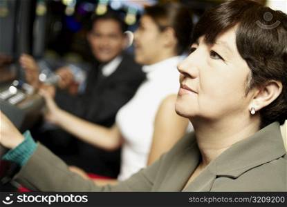 Side profile of a mature woman looking at a slot machine
