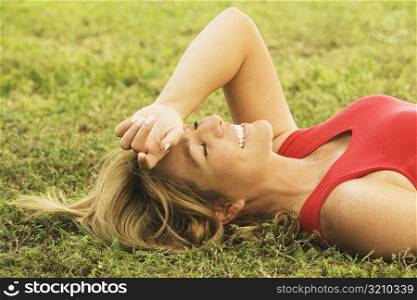 Side profile of a mature woman lying on the lawn