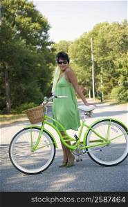 Side profile of a mature woman posing with a bicycle