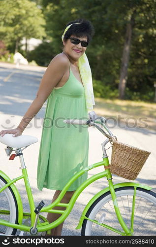 Side profile of a mature woman posing with a bicycle