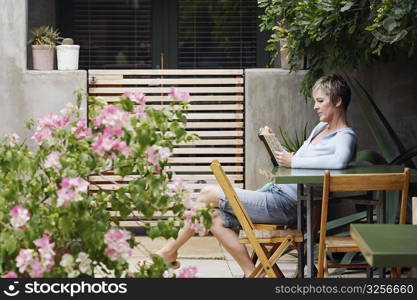 Side profile of a mature woman reading a book