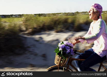 Side profile of a mature woman riding a bicycle