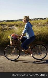 Side profile of a mature woman riding a bicycle